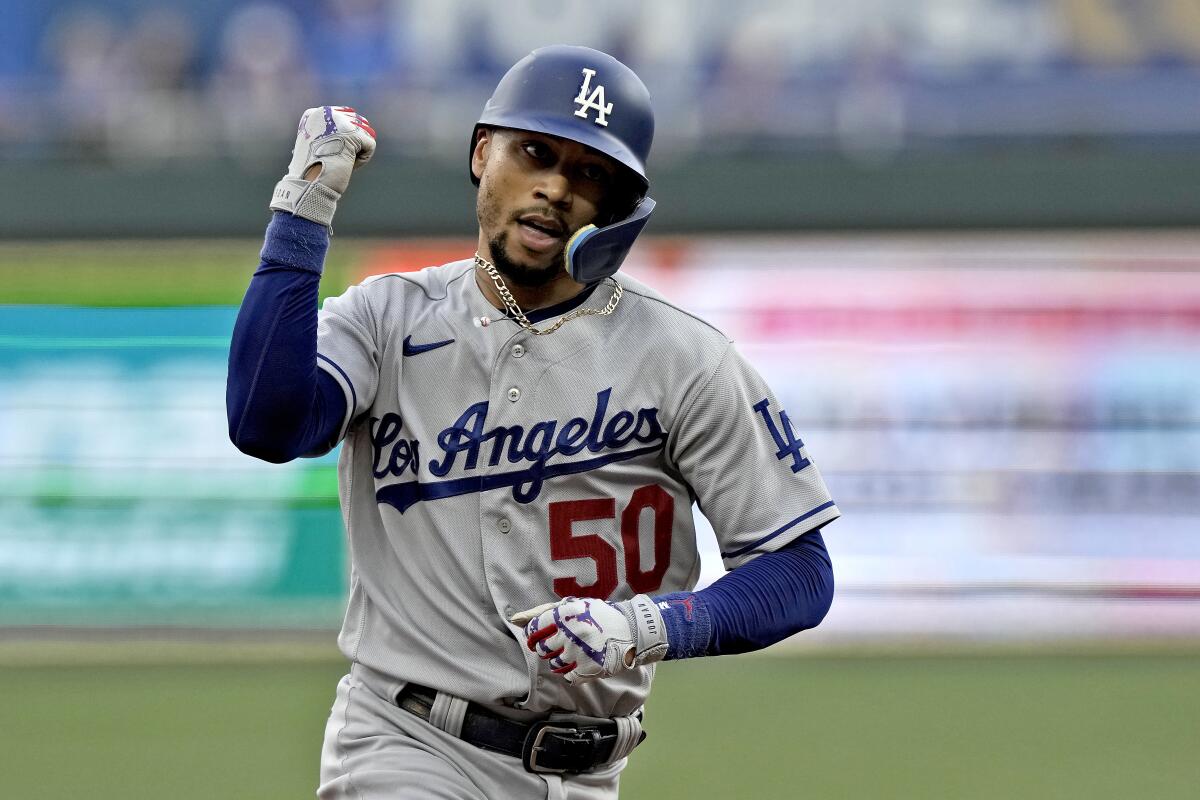 Dodgers' Mookie Betts runs the bases after hitting a home run