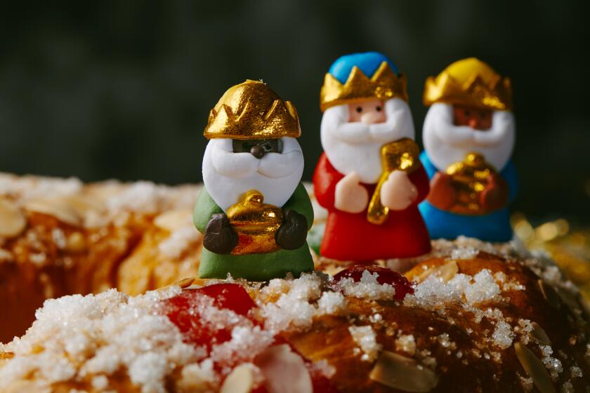 The three wise men, Melchior, Caspar and Balthazar, on top of a Three Kings cake.