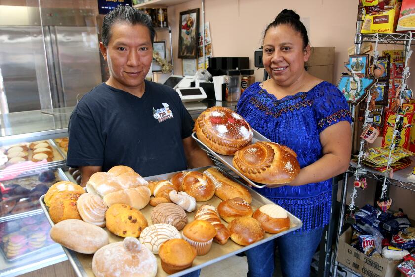 Alejandro Chanax and his wife Johana Gonzalez show some of their Guatemalan and Mexican baked goods.