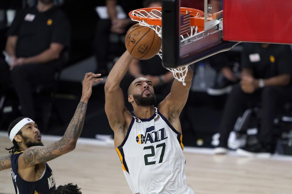 Utah Jazz's Rudy Gobert (27) heads to the basket past New Orleans Pelicans' Brandon Ingram.