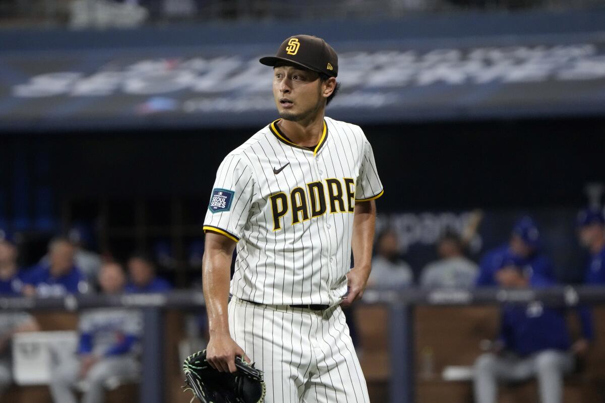 Padres starting pitcher Yu Darvish walks to the dugout after being relieved during the fourth inning of Wednesday's game.