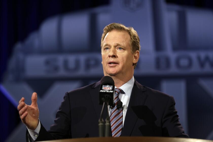 NFL Commissioner Roger Goodell talks to reporters during a news conference in Phoenix before Super Bowl XLIX.