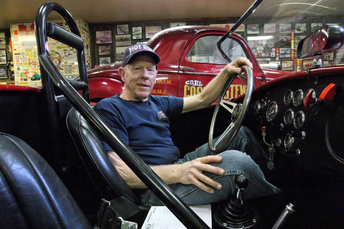 La Canada resident Lynn Park sits in the driver's seat of a Ford AC Cobra that was used in racing.