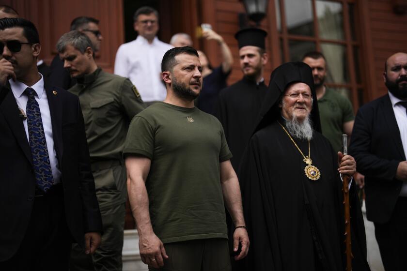 Ukrainian President Volodymyr Zelenskyy, center left, stands next to Ecumenical Patriarch Bartholomew I, the spiritual leader of the world's Orthodox Christians, at the Patriarchal Church of St. George in Istanbul, Turkey, Saturday, July 8, 2023. Zelenskyy attended a memorial ceremony for the victims of the war in Ukraine led by Patriarch Bartholomew I. (AP Photo/Francisco Seco)