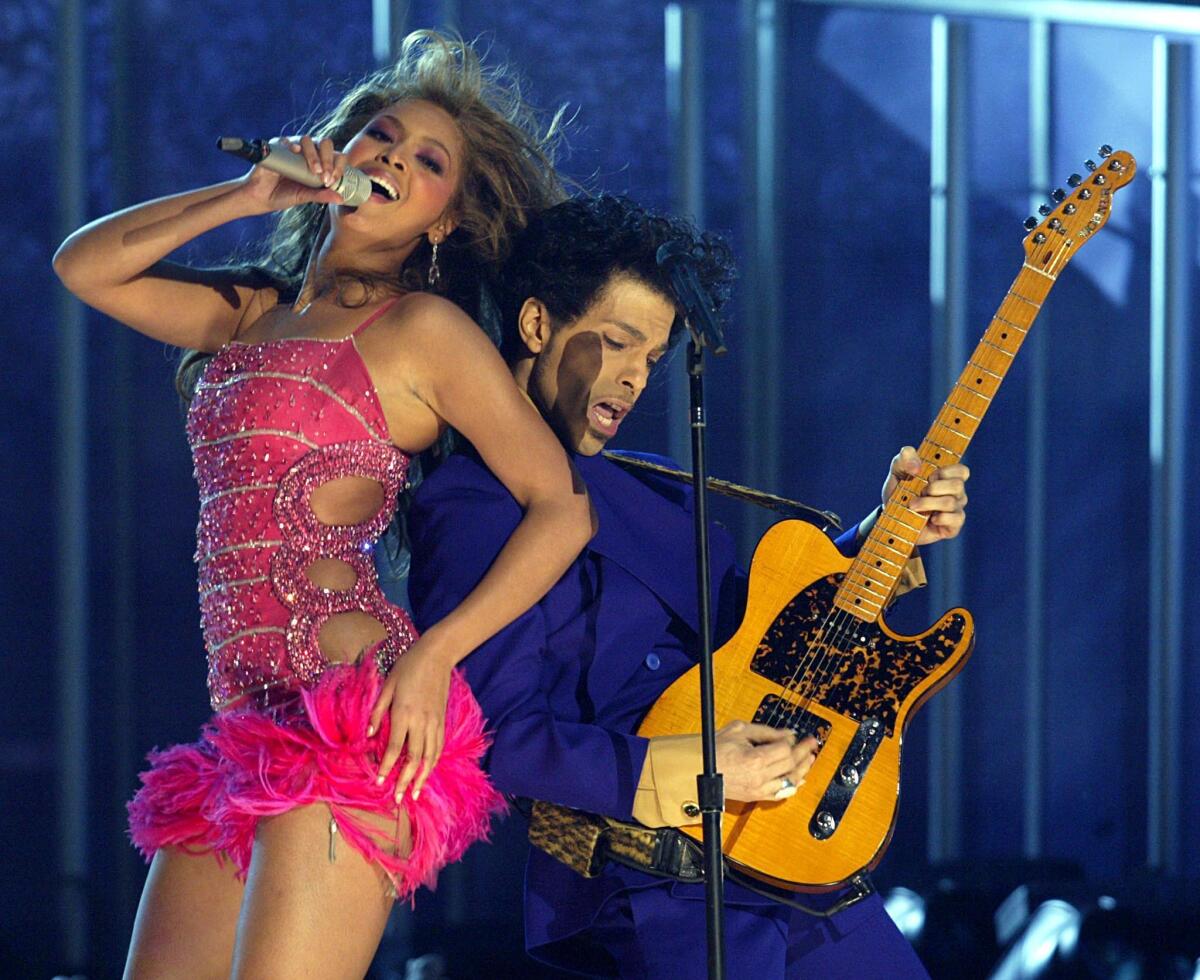 Beyoncé, left, and Prince perform together at the Grammy Awards in 2004. Bey penned the foreword to a new book of photographs of the late pop superstar.