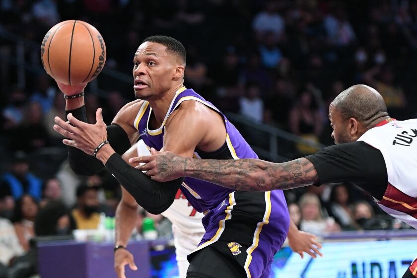 Los Angeles, California November 10, 2021: Lakers Russell Westbrook is fouled by Heats P.J. Tucker while driving to the basket in the first quarter at the Staples Center Wednesday. (Wally Skalij/Los Angeles Times)