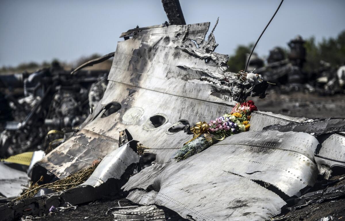 Flowers left by the parents of a passenger on the wreckage of Malaysia Airlines Flight 17 on July 26, 2014, in Ukraine.