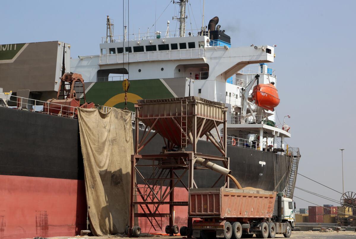 A crane unloads wheat from a cargo ship in Yemen's rebel-held Red Sea port of Hodeidah on Nov. 7, 2017.