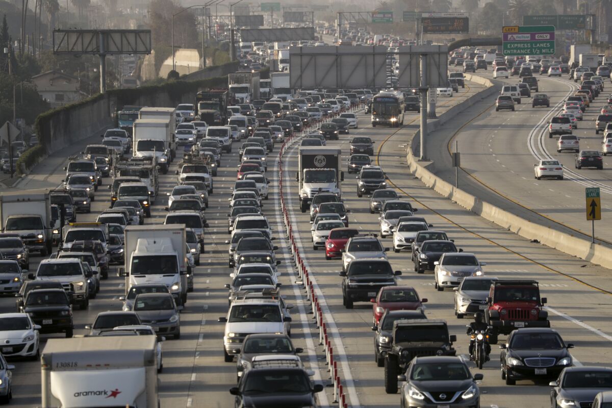A packed L.A. freeway, full of cars, trucks and other vehicles