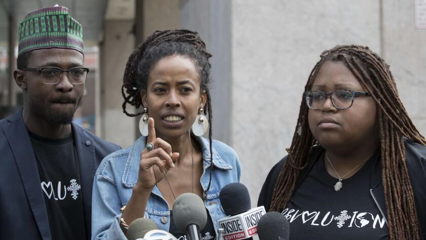 Donisha Prendergast, center, is joined by Kelly Fyffe-Marshall, right, and Komi-Oluwa Olafimihan as she speaks during a news conference on Thursday in New York.