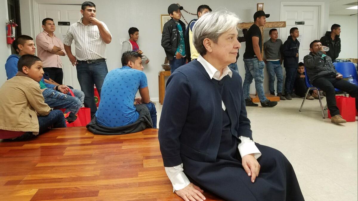 Sister Norma Pimentel, surrounded by Central American migrant families at a shelter she runs in the border city of McAllen, Texas, where she said most migrant parents are still released with notices to appear in court.