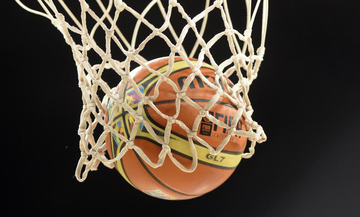 A basketball swishes through a net.