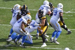 Steelers linebacker Nick Herbig (51) forces a fumble by Chargers quarterback Justin Herbert (10) in the second half.