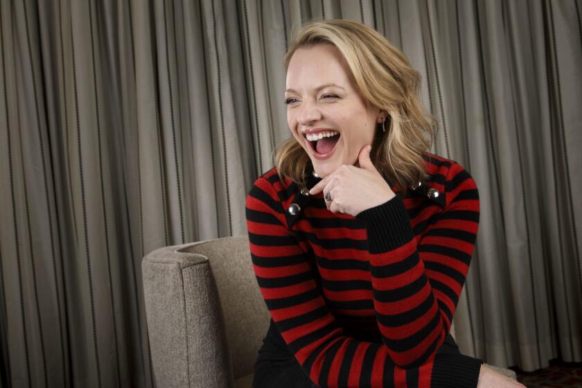 Actress Elisabeth Moss laughs during a portrait at the Four Seasons Hotel on Monday, April 3, 2017 in Los Angeles, Calif. Moss stars in her new Hulu series, "The Handmaid's Tale" based on the novel by Margaret Atwood. (Patrick T. Fallon/ For The Los Angeles Times)