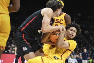 Gonzaga forward Braden Huff and USC guard Oziyah Sellers fight for the ball during a game Saturday