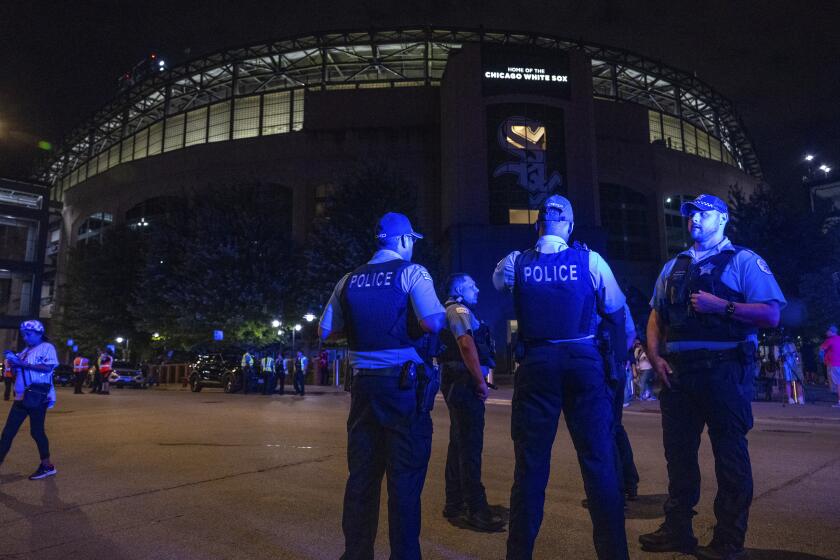 Chicago police officers stand outside Guaranteed Rate Field on Friday, Aug. 25, 2023, in Chicago. Police are investigating a shooting at the White Sox's baseball game at the stadium Friday night. Police said the investigation is ongoing. (Tyler Pasciak LaRiviere/Chicago Sun-Times via AP)