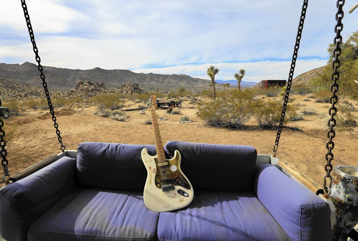 A Fender Stratocaster on a swing points to a Joshua Tree perimeter that Jim Morrison might have sung about and that has been attracting artists, musicians, mystics and the free at heart for decades.
