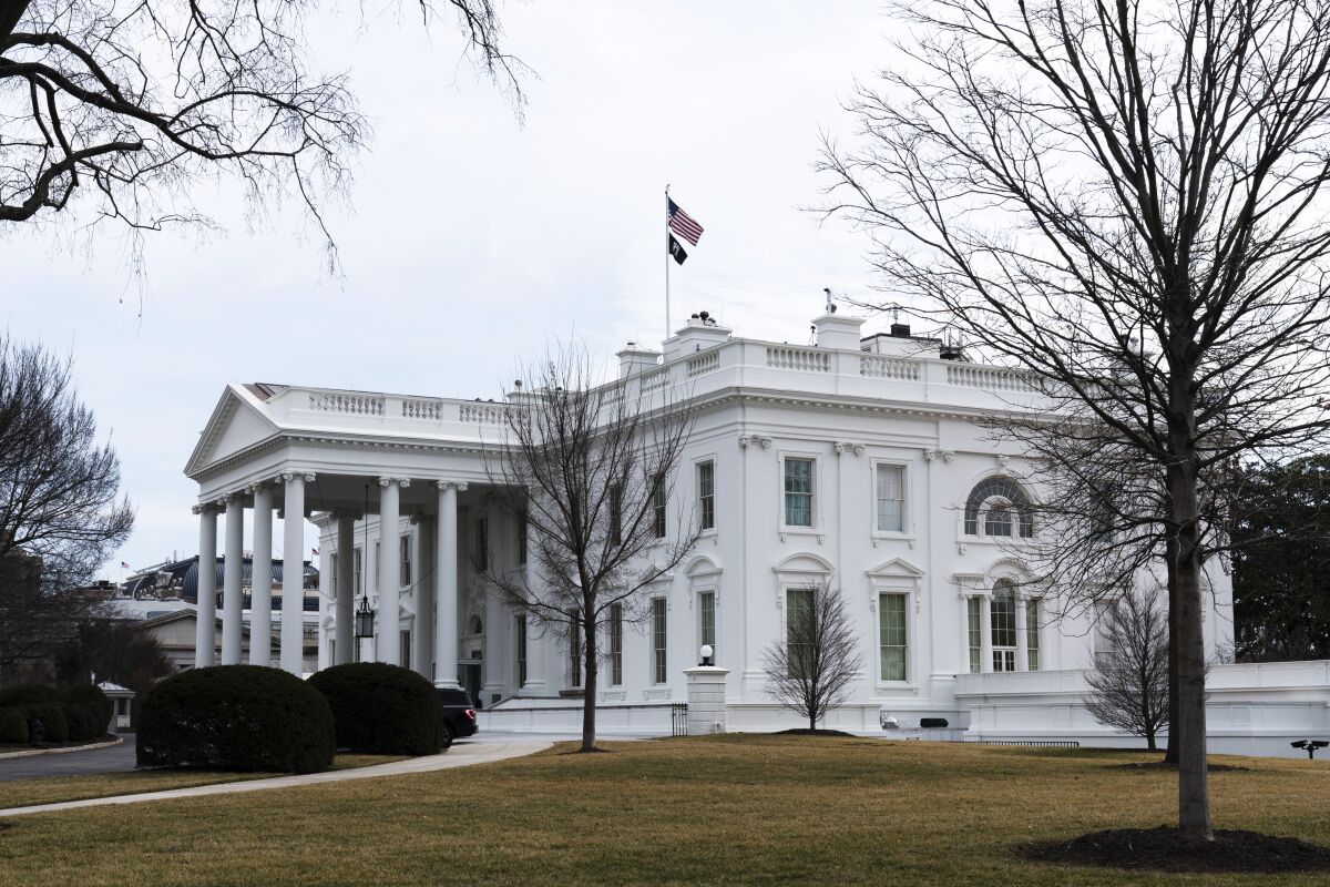 FILE - An American flag flies on top of the White House, Saturday, Feb. 12, 2022, in Washington. Public tours of the White House will resume next month after a more than 14-month hiatus due to the coronavirus, the Biden administration announced Tuesday, March 15. (AP Photo/Manuel Balce Ceneta, File)