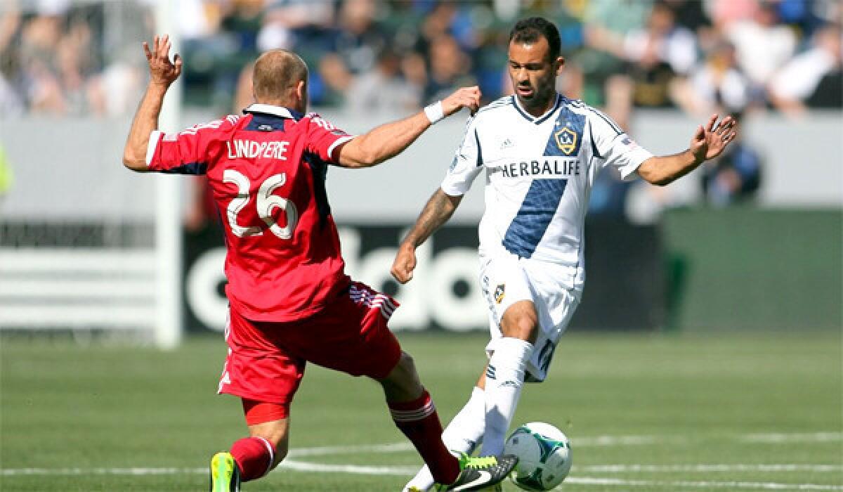 Joel Lindpere defends Juninho during the Galaxy's 4-0 victory over the Chicago Fire on March 3.