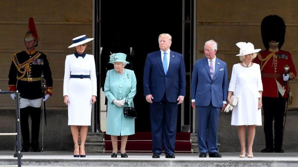 Observers noticed striking similarities between the dresses worn by First Lady Melania Trump, front far left, and the Duchess of Cornwall, front far right, who appeared Monday at Buckingham Palace with Queen Elizabeth II, President Donald Trump and Prince Charles.