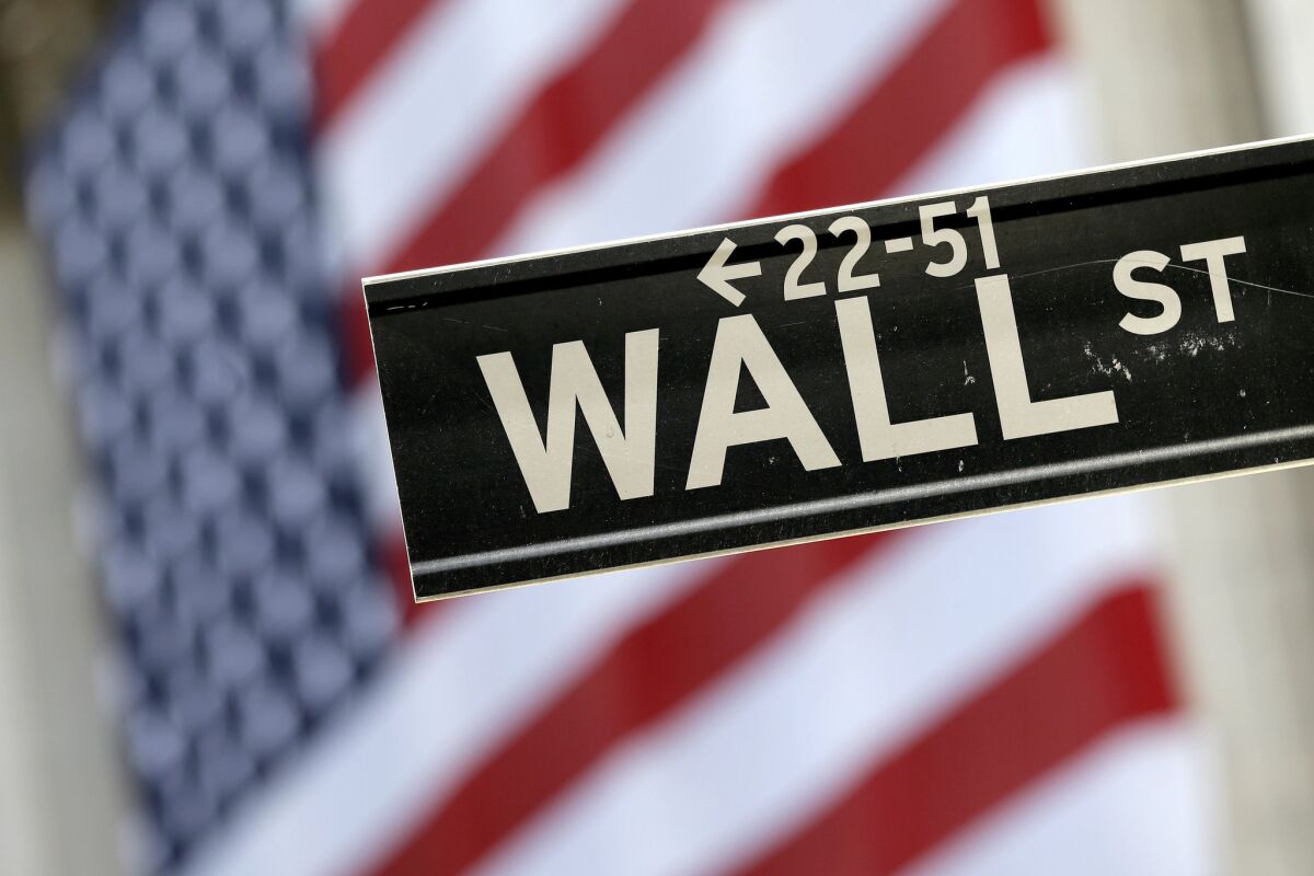 A "Wall St." street sign in front of the New York Stock Exchange.