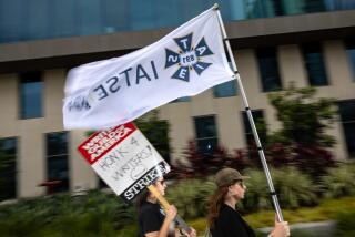 An IATSE flag flies in solidarity with the WGA and SAG-AFTRA picket line outside Netflix headquarters in July.