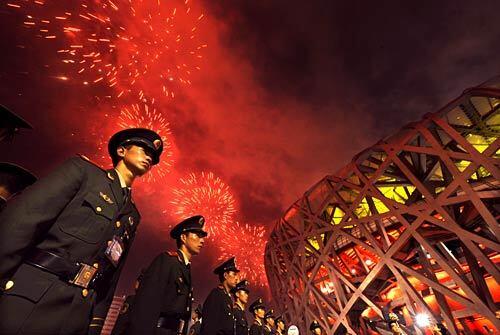 Soldiers stand outside Beijing National Stadium during closing ceremonies of the 2008 Bejing Olympics Games.