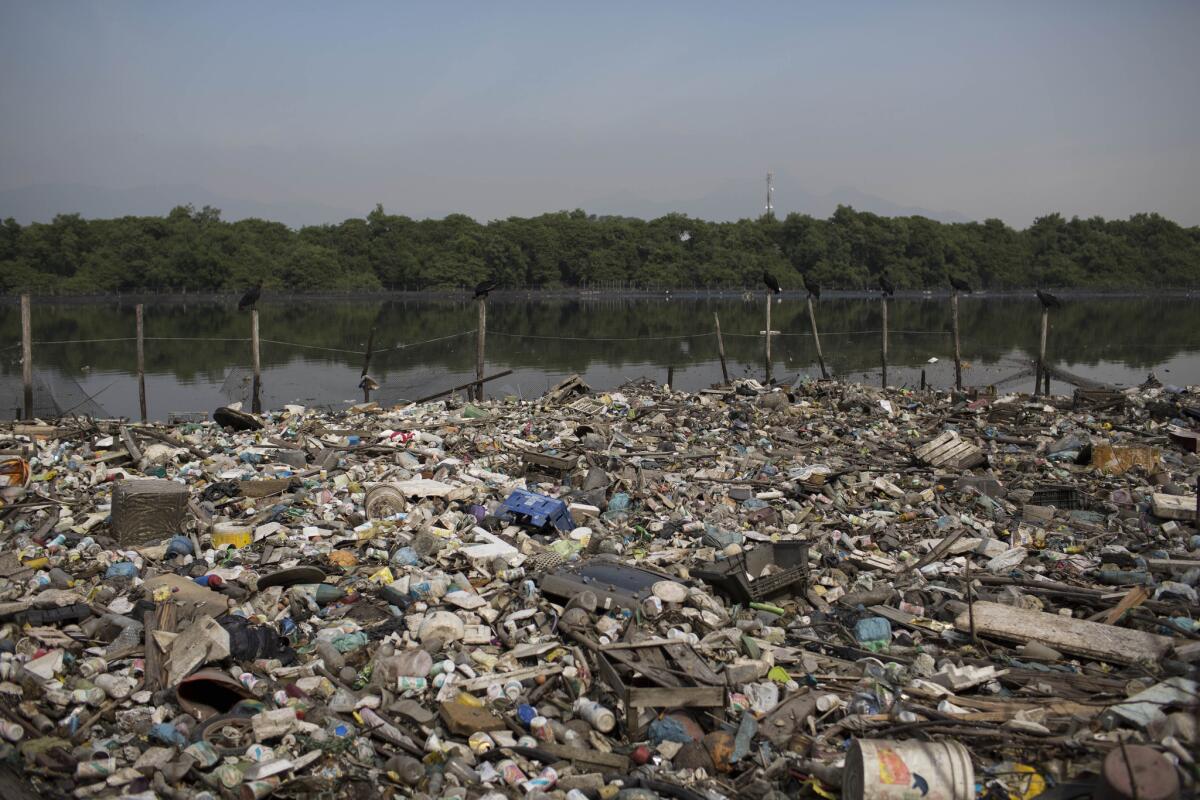 Trash floats in a water channel that flows into the Guanabara Bay in Rio de Janeiro.