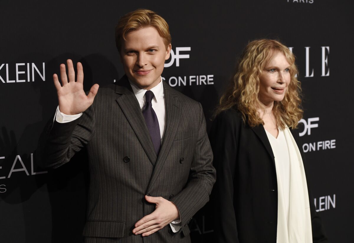 Journalist Ronan Farrow and his mother, Mia Farrow, recipient of the Elle Legend Award, arrive at the Elle Women in Hollywood event.