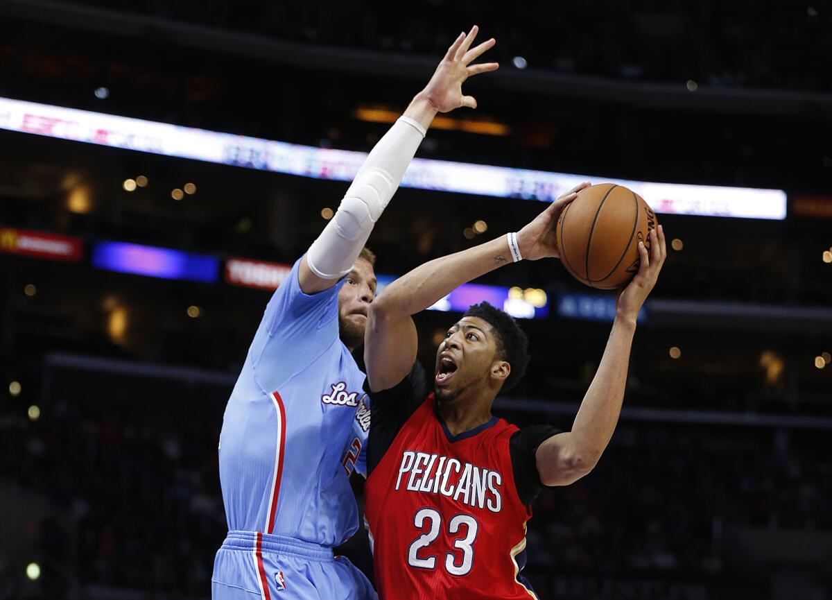 Clippers forward Blake Griffin, left, pressures New Orleans Pelicans forward Anthony Davis during the first half of a game at Staples Center on March 22, 2015.