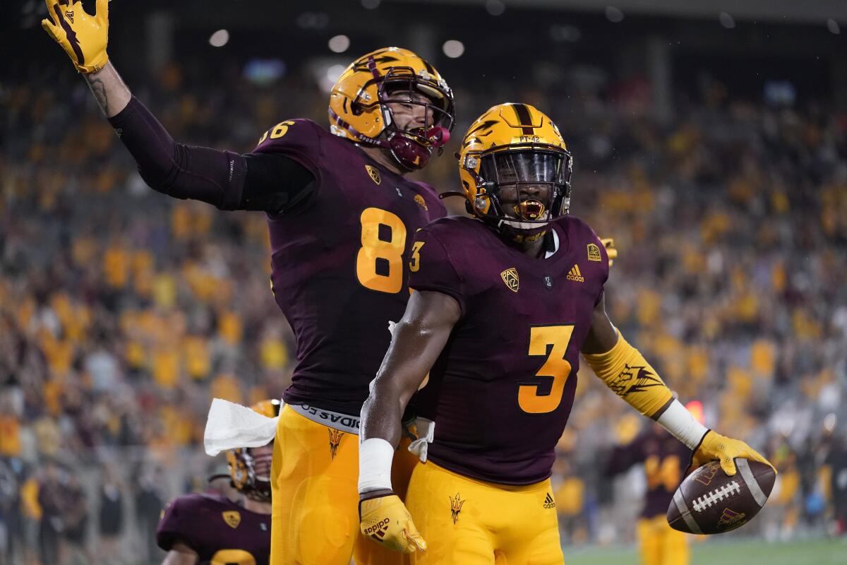 Arizona State running back Rachaad White (3) celebrates his touchdown with tight end Curtis Hodges (86) against Southern Utah during the first half of an NCAA college football game, Thursday, Sept. 2, 2021, in Tempe, Ariz. (AP Photo/Matt York)