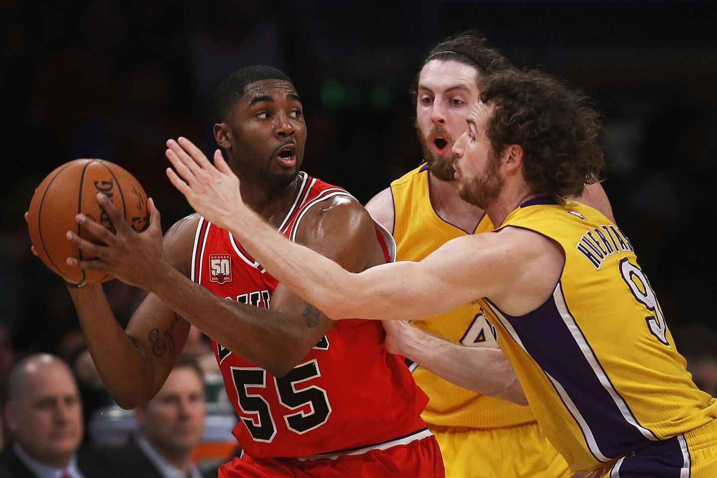 Bulls guard E'Twaun Moore is pressured by Lakers defenders Ryan Kelly and Marcelo Huertas.
