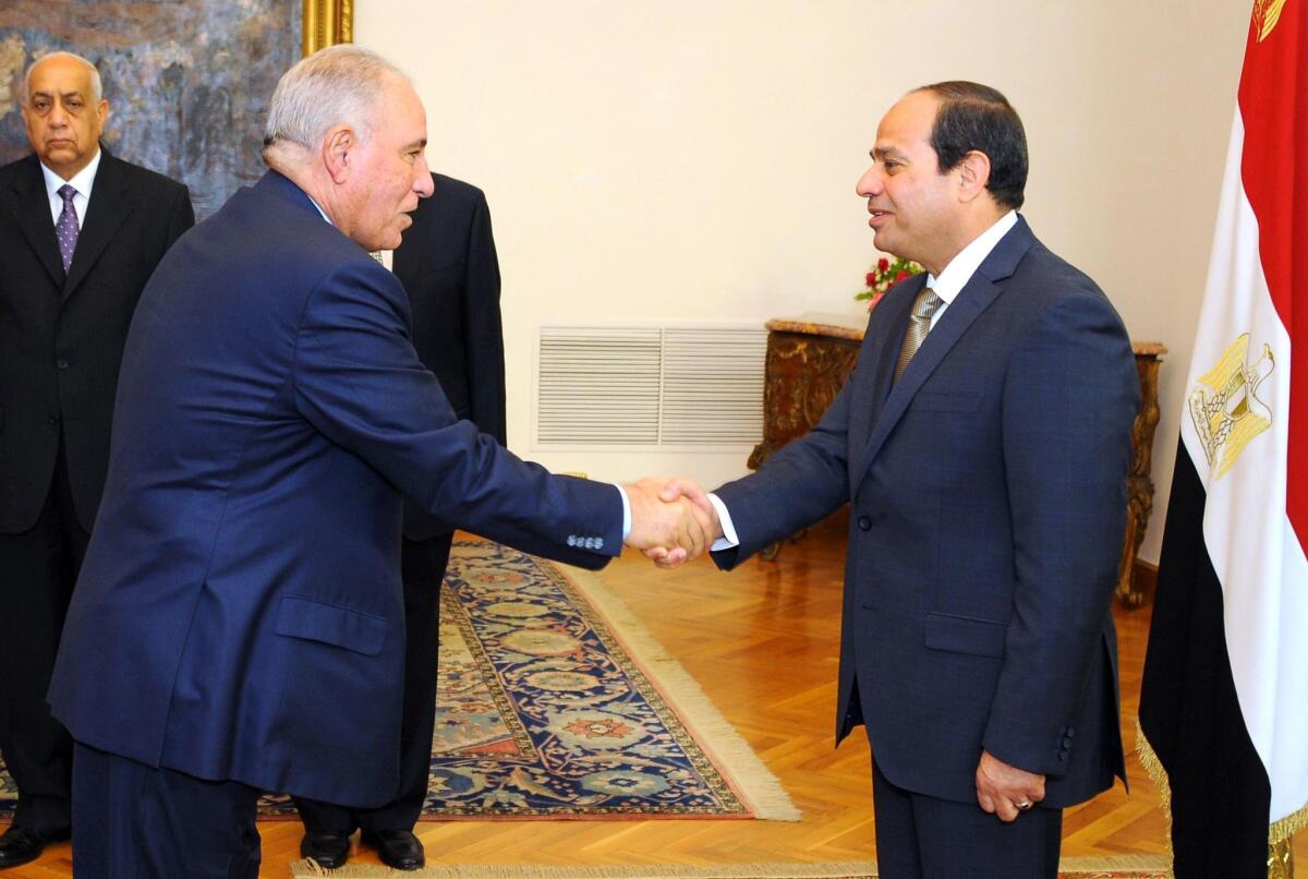 Egyptian President Abdel Fattah al-Sisi, right, shakes hands with Egypt's Justice Minister Ahmed al-Zind during his swearing-in ceremony in Cairo on May 20, 2015.