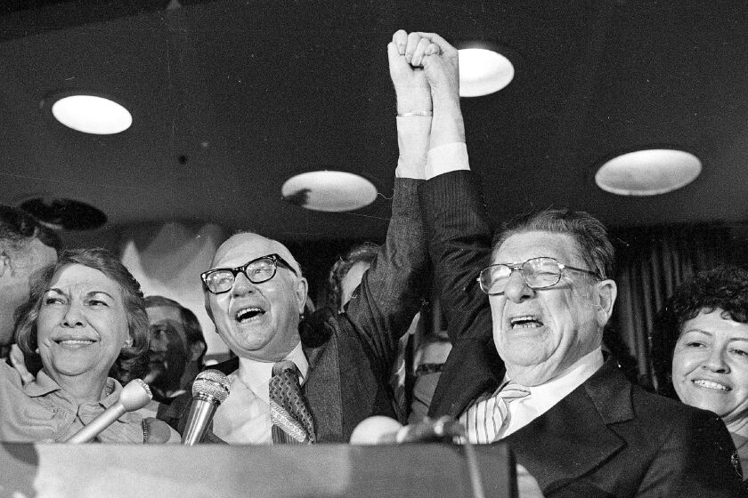 FILE - In this June 7, 1978 file photo, Howard Jarvis, right, and Paul Gann celebrate as their co-authored initiative Proposition 13 takes a commanding lead and ultimately won in the California primary in Los Angeles. On California's November, 2020 ballot, Proposition 15 would rewrite Proposition 13, the landmark 1978 measure that limits property tax increases and allows residential and commercial property to be reassessed only when it is sold. Proposition 19 would allow people 55 and older, and victims of wildfires and other disasters, to keep lower property taxes when they move to new homes. (AP Photo/File)