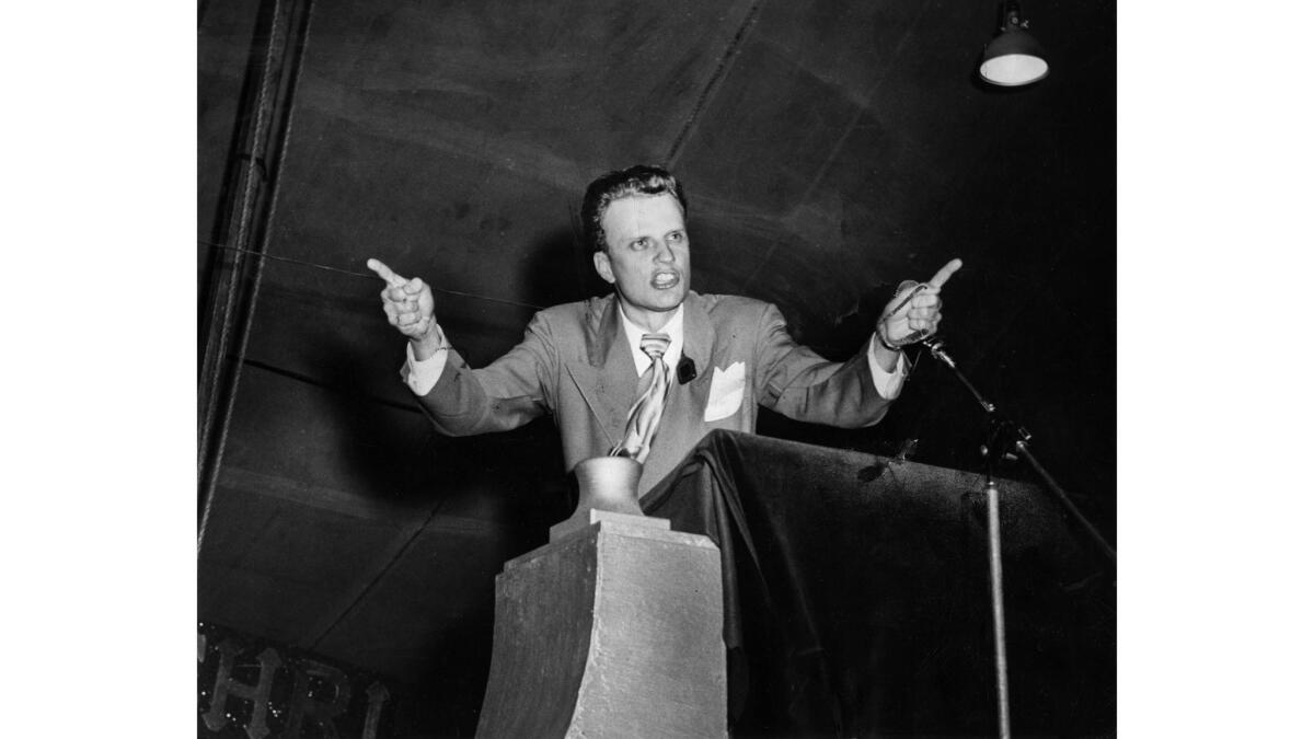Oct. 30, 1949: Dr. Billy Graham, evangelist, delivers sermon to crowd attending revival meeting in large tent at Washington Blvd. and Hill St.