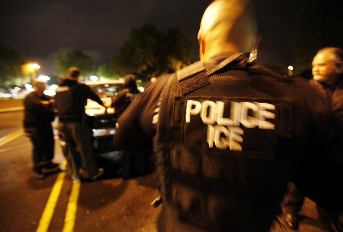 U.S. Immigration and Customs Enforcement agents, shown during a 2012 raid in Los Angeles, will no longer round up immigrants who are in the country illegally at Kern County courthouses.