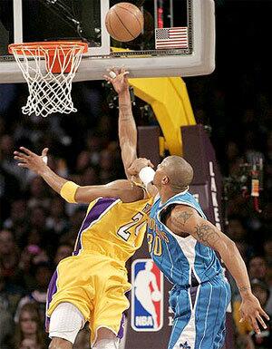 Lakers guard Kobe Bryant is fouled on a layup in the final minute of overtime by Hornets forward David West. Bryant made the basket and free throw to help seal with win.