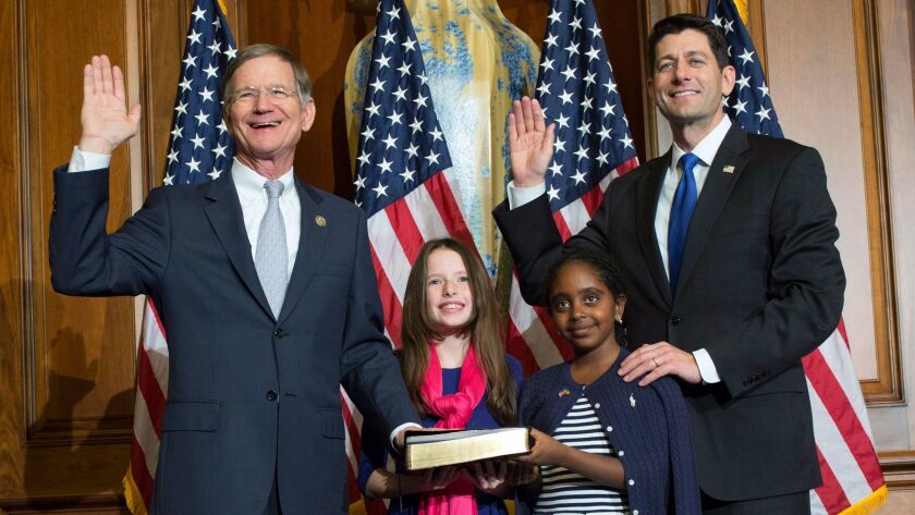 Rep. Lamar Smith (R-Texas), left, takes the oath of office from House Speaker Paul D. Ryan (R-Wis.) in January. The current term of the climate change denier will be his last.