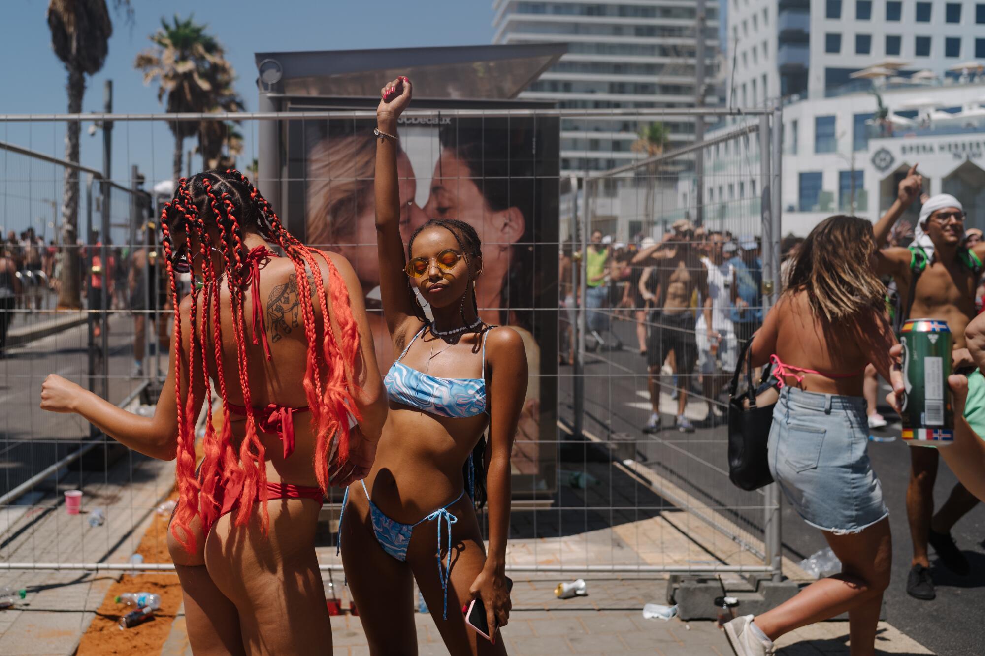 Two woman dance near the beach. 