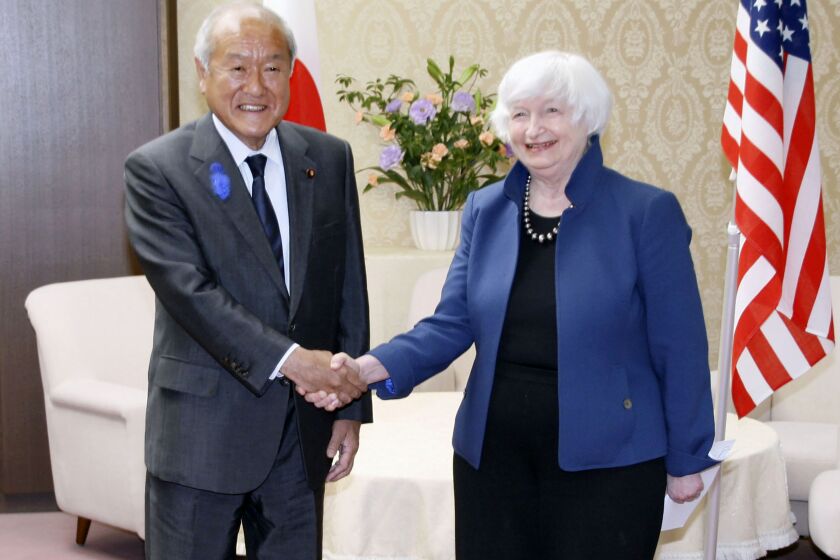 U.S. Treasury Secretary Janet Yellen, right, and Japan's Finance Minister Shunichi Suzuki shake hands during their meeting at the finance ministry in Tokyo, Tuesday, July 12, 2022. With thousands of sanctions already imposed on Russia to flatten its economy, the U.S. and its allies are working on new measures to starve the Russian war machine while also stopping the price of oil and gasoline from soaring to levels that could crush the global economy. (Kyodo News via AP)