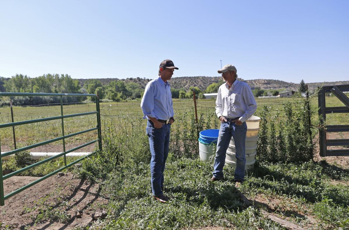 Rancher Jarod Ray, right, talks with U.S. Sen. Martin Heinrich (D-N.M.) at his ranch in Aztec, N.M. Heinrich joined the local fire department to deliver water to residents affected by the Gold King Mine spill that occurred in the Animas River in Colorado.