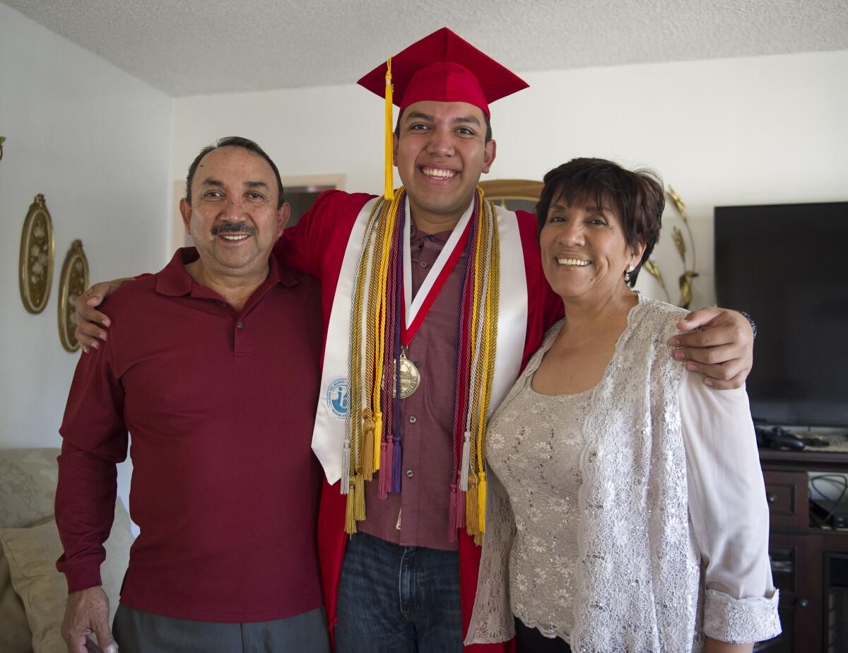 Fernando Rojas, a senior at Fullerton High School, stands with his parents, Raul Rojas and Maria, in Fullerton. Rojas was accepted into all eight Ivy League schools. He is planning on attending Yale University in the fall.