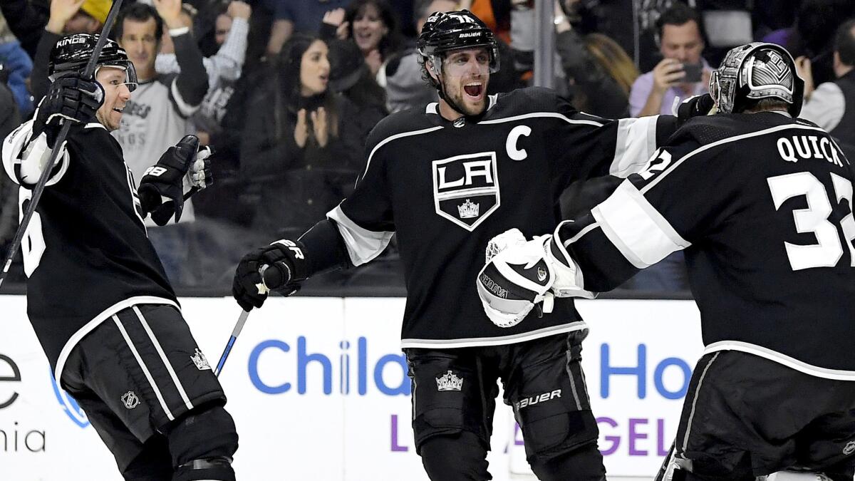 Goalie Jonathan Quick celebrates the Kings' shootout victory with left wing Jussi Jokinen, left, and center Anze Kopitar on Saturday night.