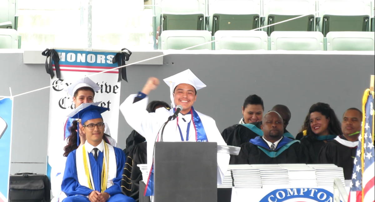 Jeffrey Acevedo cheers at the podium of Compton HIgh School's graduation, moments after coming out to his classmates as gay. (Courtesy of Jeffrey Avecedo)
