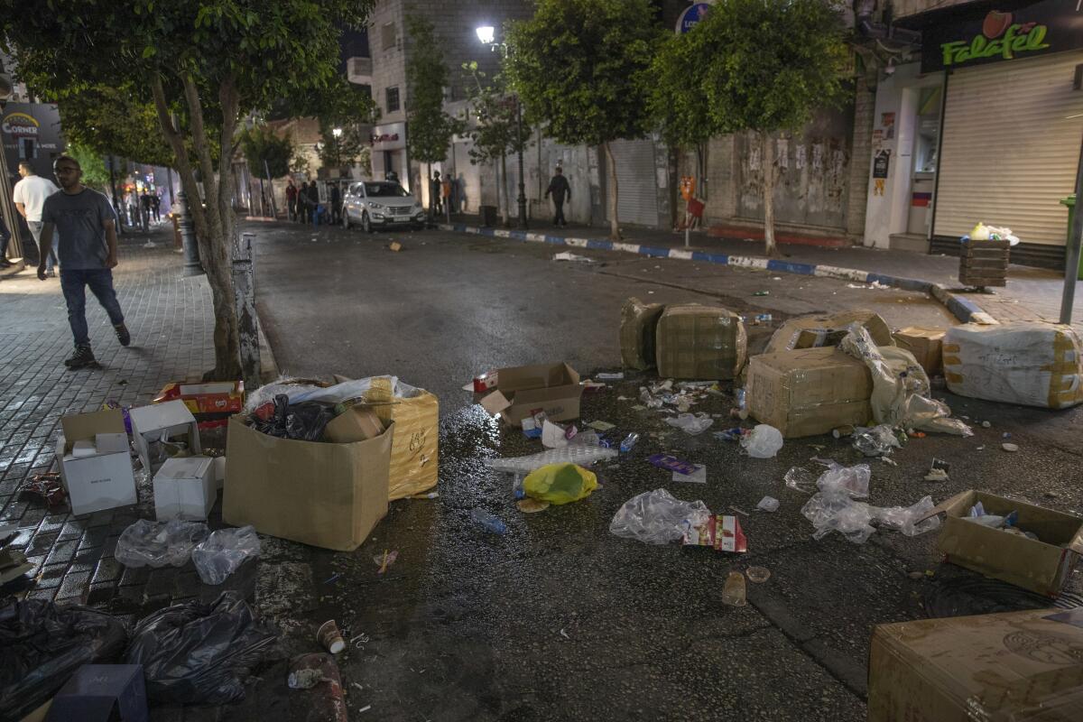 A street is blocked by debris.