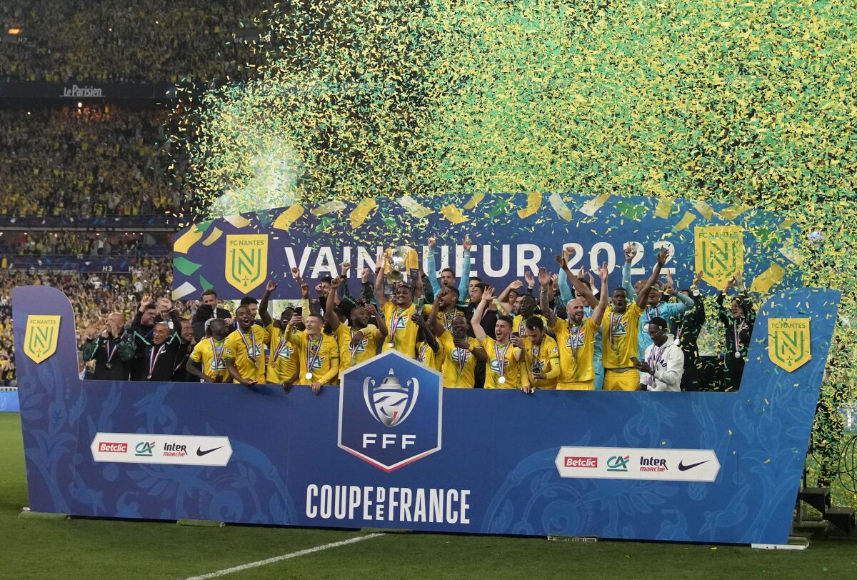 Nantes' players celebrate with the trophy after winning the French Cup final soccer match between Nice and Nantes at the Stade de France stadium, in Saint Denis, north of Paris, Saturday, May 7, 2022. (AP Photo/Christophe Ena)