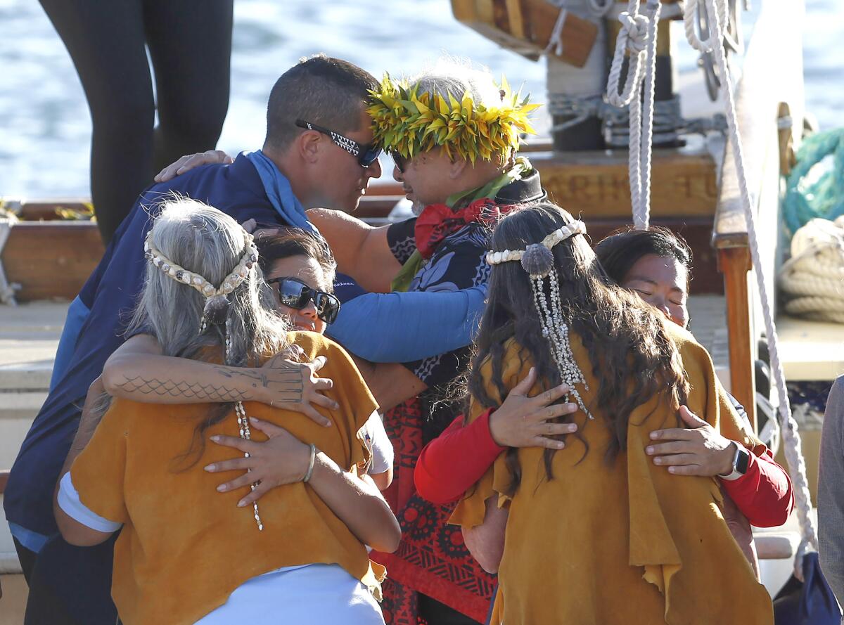 The crew of the Hawaiian canoe boat Hokule‘a is greeted at the dock to a traditional arrival ceremony.