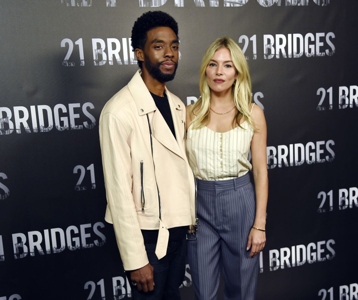 Actors Chadwick Boseman and Sienna Miller appear together at an event for the 2019 film, "21 Bridges."
