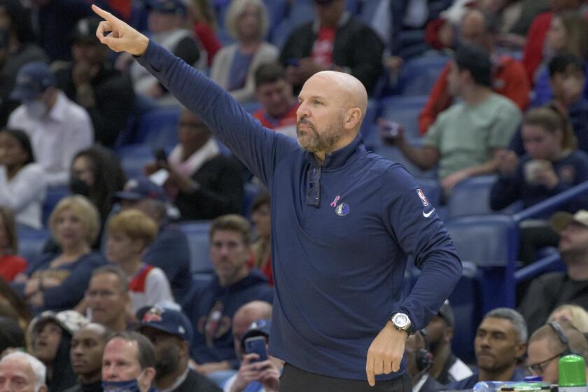 Dallas Mavericks head coach Jason Kidd points in the first half of an NBA basketball game.