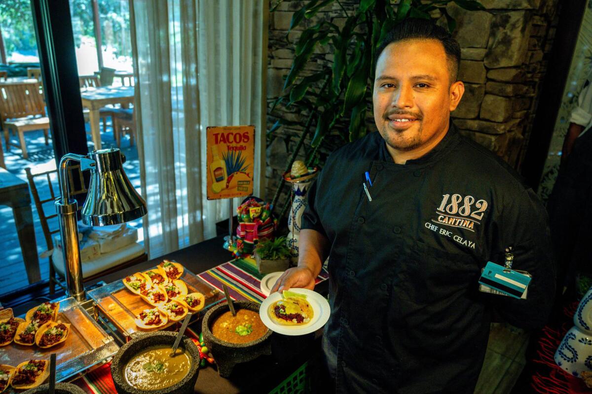 Chef Eric Celaya holds a beef cheek taco at Pechanga Resort Casino.